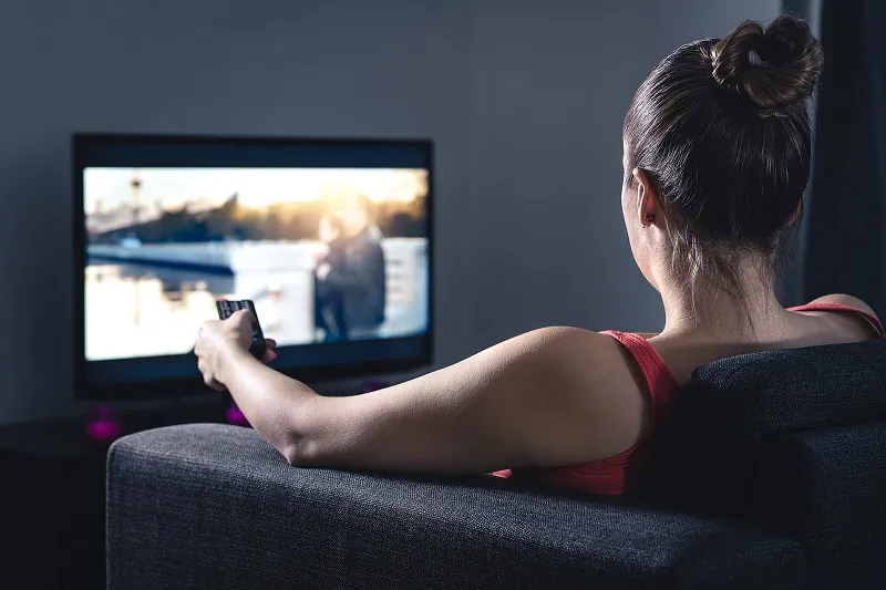 Woman watching shows on a streaming TV app